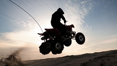 Person riding four-wheeler in the sand
